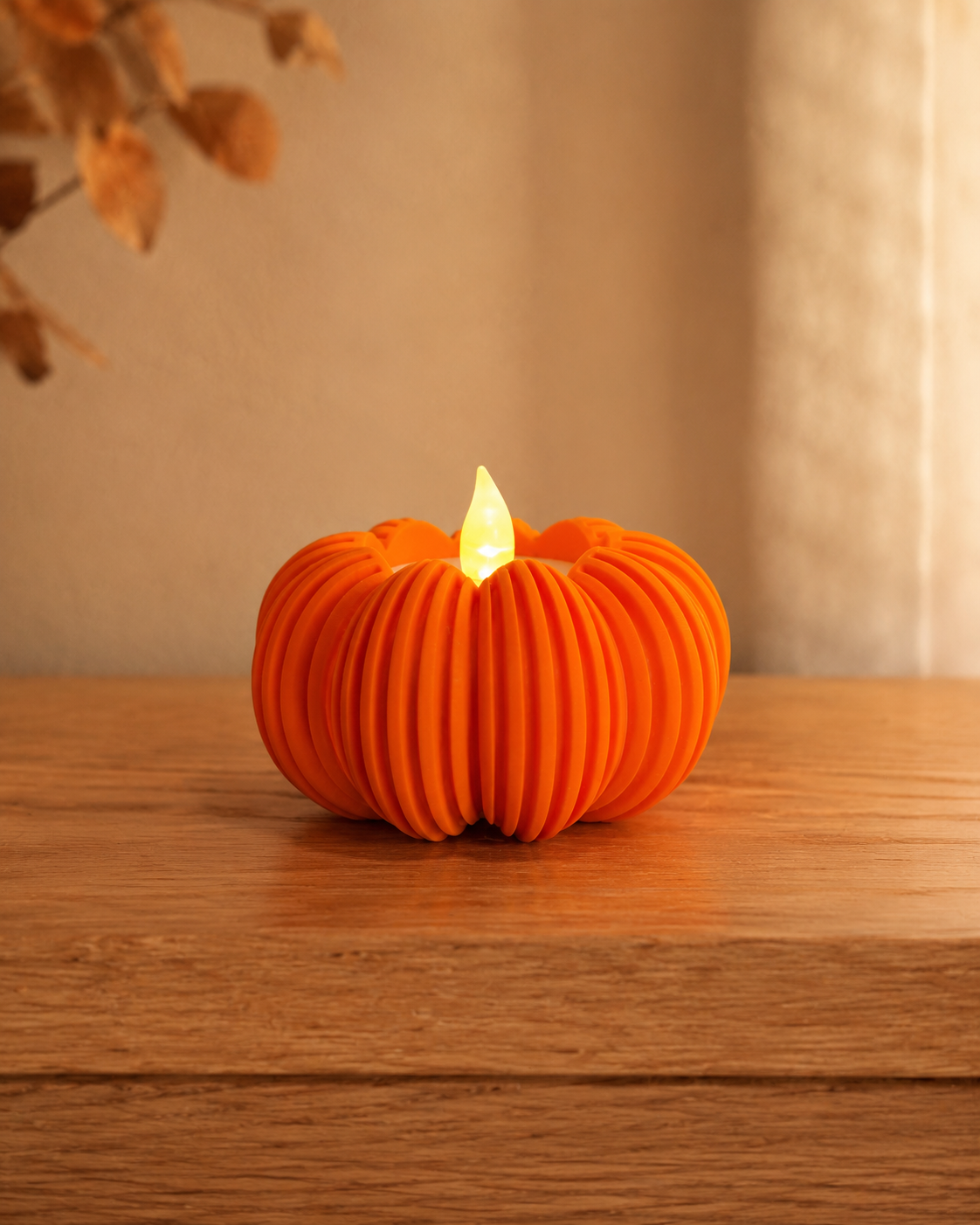 3D-printet oransje Halloween-gresskar med LED-lys på trebord